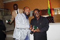 Amb. Kwesi Ahwoi and a member of the Ghana community in South Africa