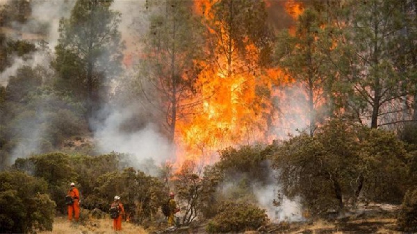 Fire fighters at the site of the Rocky wildfire spreading through California