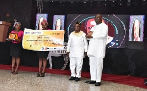NIB management with the GHC50,000 cheque donation at Annual MUSIGA Presidential Grand Ball