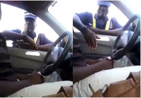 A police officer taking money from a driver
