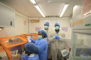 Medical workers test for the Ebola virus in a mobile lab set in Butembo