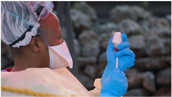 A health worker prepares a vaccine against Ebola in Goma