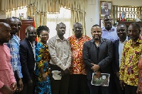 Management and staff of YFM in a group photograph with the minister