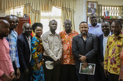 Management and staff of YFM in a group photograph with the minister