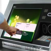File photo; A customer using an automated teller machine