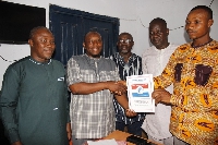 Members of the local government service presents the forms to Issah Kpegla Jnr