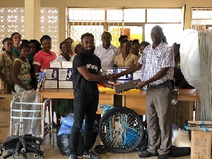 Magnus Rex Danquah presenting the items to the hospital