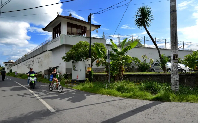 Motorists ride past the notorious Kerobokan prison where two of the 'Bali Nine' were being held