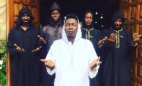 Shatta Wale (in white) has threatened to burn some churches if he is alive by December