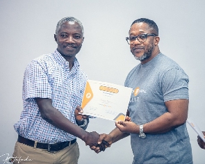 Dr. David Okyere, Head of Agency Banking presents certificate to Patrick Amankwah Arthur