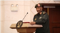 Sudan's military leader General Abdel Fattah al-Burhan stands at the podium during a ceremony