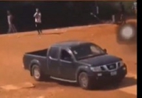 A man shooting at a vehicle during the clash