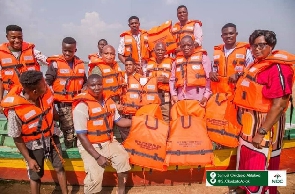 Samuel Okudzeto Ablakwa in a group picture with boat operators wearing life jackets