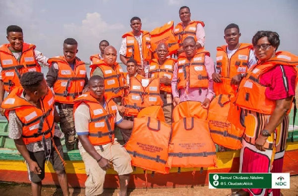 Samuel Okudzeto Ablakwa in a group picture with boat operators wearing life jackets