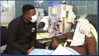 GhanaWeb's Etsey Atisu interacting with one of the patients on dialysis