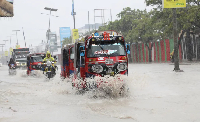 Tuktuks navigate floodwater on KM4 street in Mogadishu, Somalia, following a heavy downpour