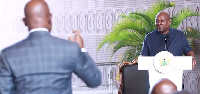 Mark Addo (L) explaining to President Mahama about the name change
