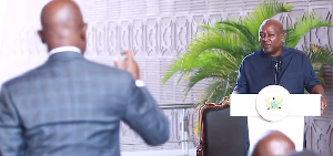 Mark Addo (L) explaining to President Mahama about the name change