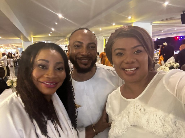 Mantsebi Ago sandwiched by wife Bridget Otoo and Mrs. Charlotte Osei