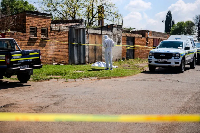 Forensic officer works at scene where sixth body was found in KwaThema, Springs