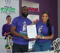 Andrew Kojo Kyere,MD of Drews Pharmacy with Serwaa Amihere, with the agreement signed