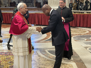 Pope Leo XIV (in red and white attire) blesses Okudzeto Ablakwa (in black suit)