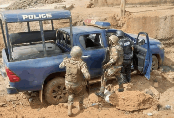An abandoned police vehicle at the site of the clash