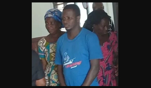 Newell Gavu (middle) being aided to court some family members