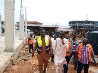 A picture of Dr Frank Amoakohene touring the district model market