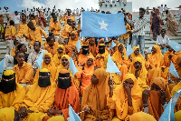 Residents wave Somali flags at a Mogadishu rally