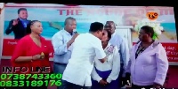 Pastor performing miracle on female congregant by kissing her