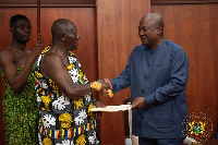 The Asantehene presenting the report to President John Dramani Mahama