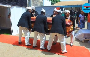 Pallbearers carry the remains of Wili Roi