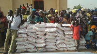 Conflict victims standing behind NADMO relief items