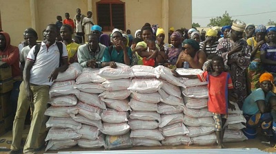 Conflict victims standing behind NADMO relief items