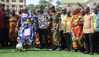 Otumfuo (in blue kente) scored a penalty kick at a ceremonial event