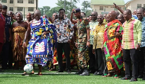 Otumfuo (in blue kente) scored a penalty kick at a ceremonial event