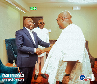 Dr. Mahamudu Bawumia (in suit) shaking the hands of John Dramani Mahama (in white smock)