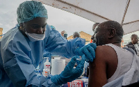 A Congolese health worker receives a vaccination in North Kivu province