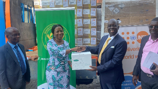 Professor Grace Ayensu-Danquah (L) receiving the items on behalf of the Ministry