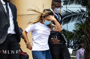 Aisha Huang (middle) being quarded by security officers