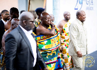 Otumfuo Osei Tutu II arriving at the event with President Mahama (R)