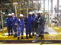 Ben Harris (R), Offshore Installation Manager, Tullow, taking the delegation through the operations