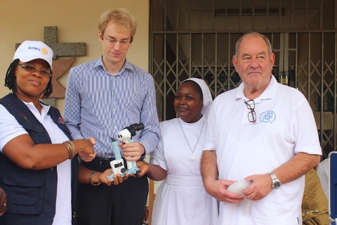 Madam Kudjoe, Ho Rotary Club President presenting a slit lamp  Margret Marquart Catholic Hospital