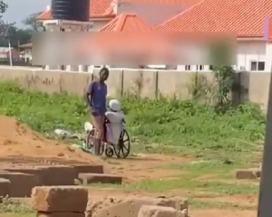 Screenshot from video of two individuals posing to be disabled street beggar and his aide