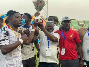 Albert Commey lifts the trophy high