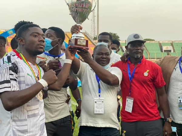 Albert Commey lifts the trophy high