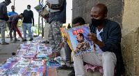 Ethiopians read newspapers reporting on the current military confrontation in the country