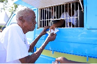 An elderly man receives money under the Social Assistance Grants for Empowerment