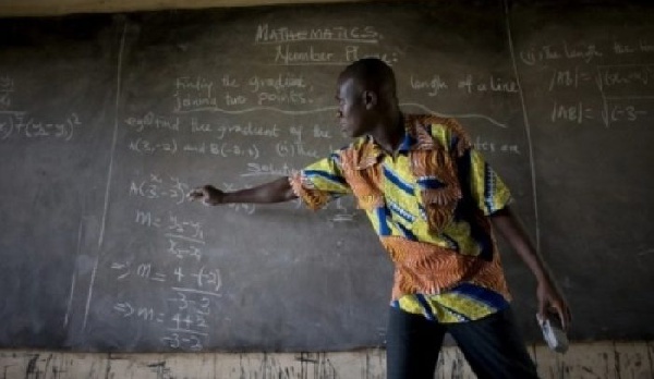 File photo: A teacher taking his pupils through lessons